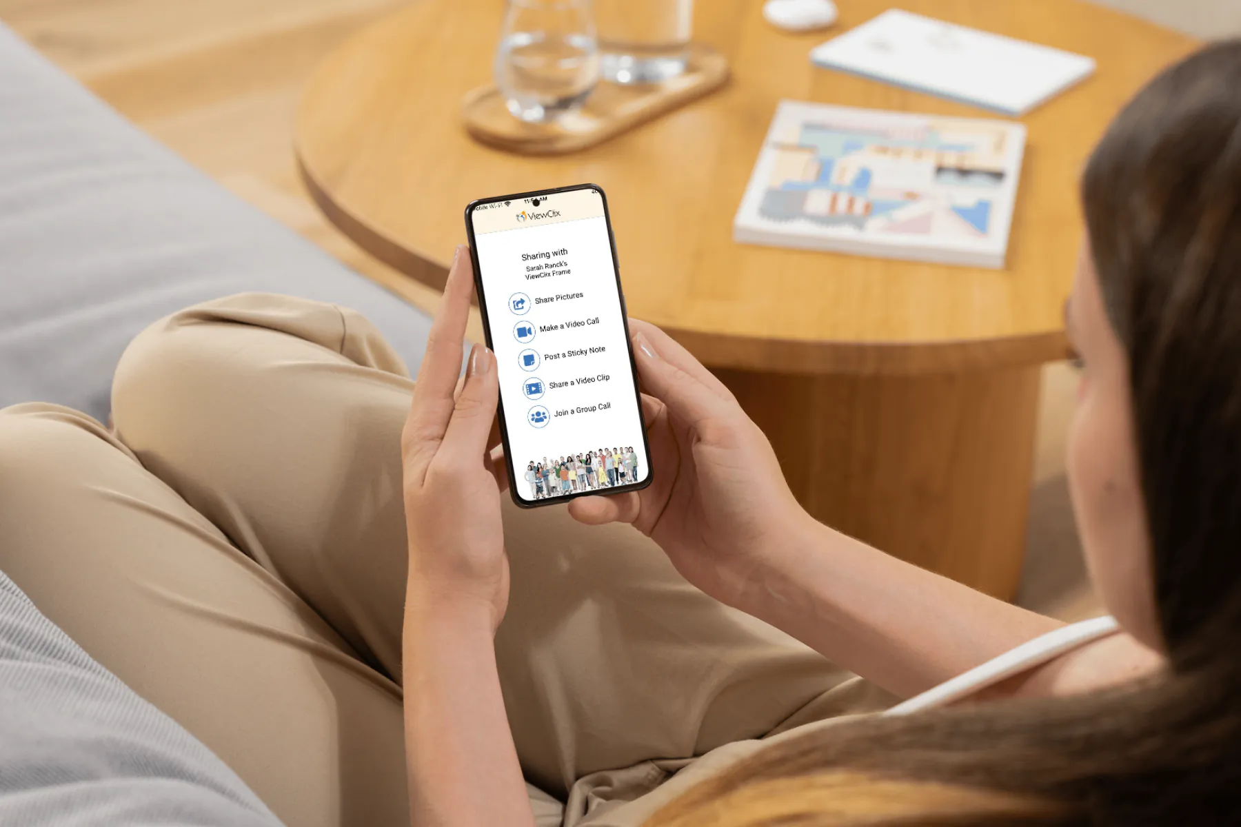 A family member using the ViewClix app to share pictures, make video calls, and post notes